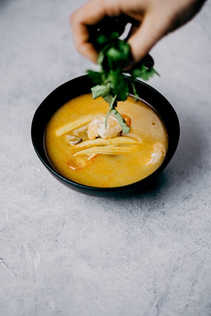 Savor this flavorful shrimp soup with baby corn and cilantro, perfect for Asian cuisine lovers.